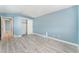 Bedroom with light blue walls, wood-look floors and a large closet at 3008 Blush Noisette Ave, North Las Vegas, NV 89081