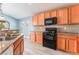 Bright kitchen featuring wood cabinets, granite countertops, and modern appliances at 3008 Blush Noisette Ave, North Las Vegas, NV 89081