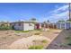 Ranch-style home with a red door and gravel driveway at 309 Wisteria Ave, Las Vegas, NV 89107