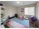 Bedroom with double bed, built-in shelving, and large window at 315 Bay Village Pl, Henderson, NV 89011