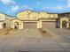 Three-unit townhome complex with two-car garages and paver driveways at 315 Bay Village Pl, Henderson, NV 89011