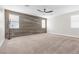 Spacious bedroom with wood-like accent wall and ceiling fan at 315 Rhiannon Ct, Las Vegas, NV 89183