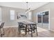 Bright dining room featuring a large table, modern light fixture, and sliding glass doors leading to the backyard at 315 Rhiannon Ct, Las Vegas, NV 89183