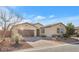 Single-story home with a brown garage door and landscaped front yard at 315 Rhiannon Ct, Las Vegas, NV 89183