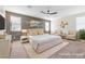 Main bedroom with virtually staged furniture, wood wall accent, and neutral color palette at 315 Rhiannon Ct, Las Vegas, NV 89183