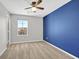 Bright bedroom with blue accent wall and ceiling fan at 3494 Brezine Ave, Henderson, NV 89044