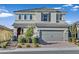 Two-story house with gray siding, red door, and a paved driveway at 3494 Brezine Ave, Henderson, NV 89044