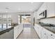 Modern kitchen with white cabinets, granite counters, and island at 3494 Brezine Ave, Henderson, NV 89044