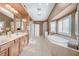 Luxurious bathroom featuring a large soaking tub and double vanity at 3733 Via Di Girolamo Ave, Henderson, NV 89052