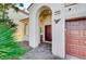 Inviting entryway with a charming arched entry and a wooden door at 3733 Via Di Girolamo Ave, Henderson, NV 89052