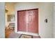 Double front doors with a welcome mat and sidelights at 3733 Via Di Girolamo Ave, Henderson, NV 89052