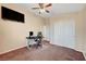 Bright home office features a desk, chair, and large TV at 3733 Via Di Girolamo Ave, Henderson, NV 89052