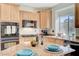 Spacious kitchen with granite island, stainless steel appliances, and wood cabinets at 3733 Via Di Girolamo Ave, Henderson, NV 89052