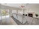 Relaxing living room featuring fireplace and grey sectional sofa at 3733 Via Di Girolamo Ave, Henderson, NV 89052