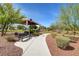 Landscaped park with a walking path and benches at 3733 Via Di Girolamo Ave, Henderson, NV 89052