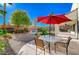 Outdoor patio furniture under a red umbrella at 3733 Via Di Girolamo Ave, Henderson, NV 89052