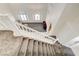 Elegant staircase with white railings overlooking the living room at 3733 Via Di Girolamo Ave, Henderson, NV 89052