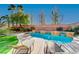 Relaxing kidney-shaped pool with tanning ledges and lounge chairs at 3733 Via Di Girolamo Ave, Henderson, NV 89052