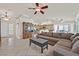 Spacious living room featuring a large sectional sofa and a view of the kitchen at 4318 Cobblehill Way, North Las Vegas, NV 89032