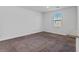 Simple bedroom with neutral carpeting and window at 4543 Pencester St, Las Vegas, NV 89115