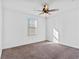 Spacious bedroom with ceiling fan and neutral carpeting at 4543 Pencester St, Las Vegas, NV 89115