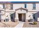 Tan two-story stucco home with brown accents, walkway, and landscaping at 4543 Pencester St, Las Vegas, NV 89115