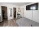 Cozy bedroom featuring modern flooring, a mirror, and TV at 4559 S Nellis Blvd, Las Vegas, NV 89121