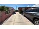 Driveway leading to a house with foliage and a privacy fence at 4559 S Nellis Blvd, Las Vegas, NV 89121