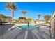 Community pool with palm trees and fencing at 4710 Blaise Ave # 101, North Las Vegas, NV 89084