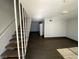 Living room with stairs, wood-look floors, and neutral walls at 520 S 13Th St # D4, Las Vegas, NV 89101