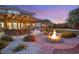 Landscaped backyard with fire pit, outdoor kitchen, and pergola at 6004 Chessington Ave, Las Vegas, NV 89131