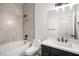 Clean bathroom with bathtub, toilet and dark vanity at 6004 Chessington Ave, Las Vegas, NV 89131