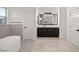 Modern bathroom with freestanding tub and dark wood cabinets at 6004 Chessington Ave, Las Vegas, NV 89131