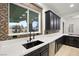 Modern kitchen with dark cabinetry, white countertops, and a stylish sink at 6004 Chessington Ave, Las Vegas, NV 89131