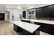 Modern kitchen with dark cabinetry, white countertops, and a large island at 6004 Chessington Ave, Las Vegas, NV 89131