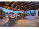 Outdoor kitchen with built-in grill, pergola, and stone countertops at 6004 Chessington Ave, Las Vegas, NV 89131