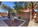 Private backyard with table, chairs, and mature trees at 634 Wounded Star Ave, Las Vegas, NV 89178