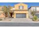 Two-story house with a two-car garage and landscaped front yard at 634 Wounded Star Ave, Las Vegas, NV 89178