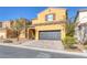 Two-story house with a two-car garage and landscaped front yard at 634 Wounded Star Ave, Las Vegas, NV 89178