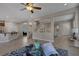 Open living room with a ceiling fan and large windows at 634 Wounded Star Ave, Las Vegas, NV 89178