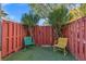 Enclosed backyard with red fence, artificial grass, and colorful seating at 656 Tam O Shanter, Las Vegas, NV 89109