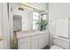 Bright bathroom with a large mirror, white vanity, and a clean, functional design at 656 Tam O Shanter, Las Vegas, NV 89109