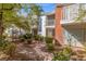 Well-manicured townhouse complex featuring brick pathways, lush greenery, and charming architecture at 656 Tam O Shanter, Las Vegas, NV 89109