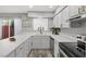 Well-lit kitchen featuring white cabinets, stainless steel appliances, and modern countertops at 656 Tam O Shanter, Las Vegas, NV 89109