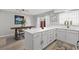 Bright kitchen with center island, white cabinetry, gold hardware, and view of dining area at 656 Tam O Shanter, Las Vegas, NV 89109