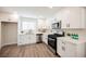 Modern kitchen with white cabinets and stainless steel appliances at 6750 Laronda Ln, Las Vegas, NV 89156