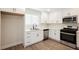 Modern kitchen with white cabinets, quartz countertops, and stainless steel appliances at 6750 Laronda Ln, Las Vegas, NV 89156