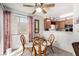 Dining area with glass table and kitchen view at 6885 Tamarus St # 201, Las Vegas, NV 89119