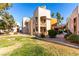 Building exterior with palm trees and grassy area at 6885 Tamarus St # 201, Las Vegas, NV 89119