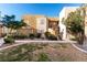 Tan two-story building with landscaping and walkways at 6885 Tamarus St # 201, Las Vegas, NV 89119